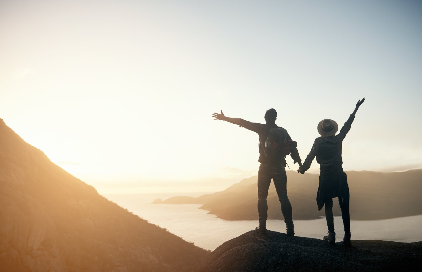 Shot of a young couple hiking the mountains in the morning